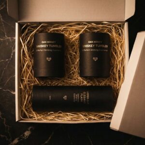 Handcrafted Oak Honey Whiskey Tumblers and Upper Cut Flask on a dark wooden home bar.